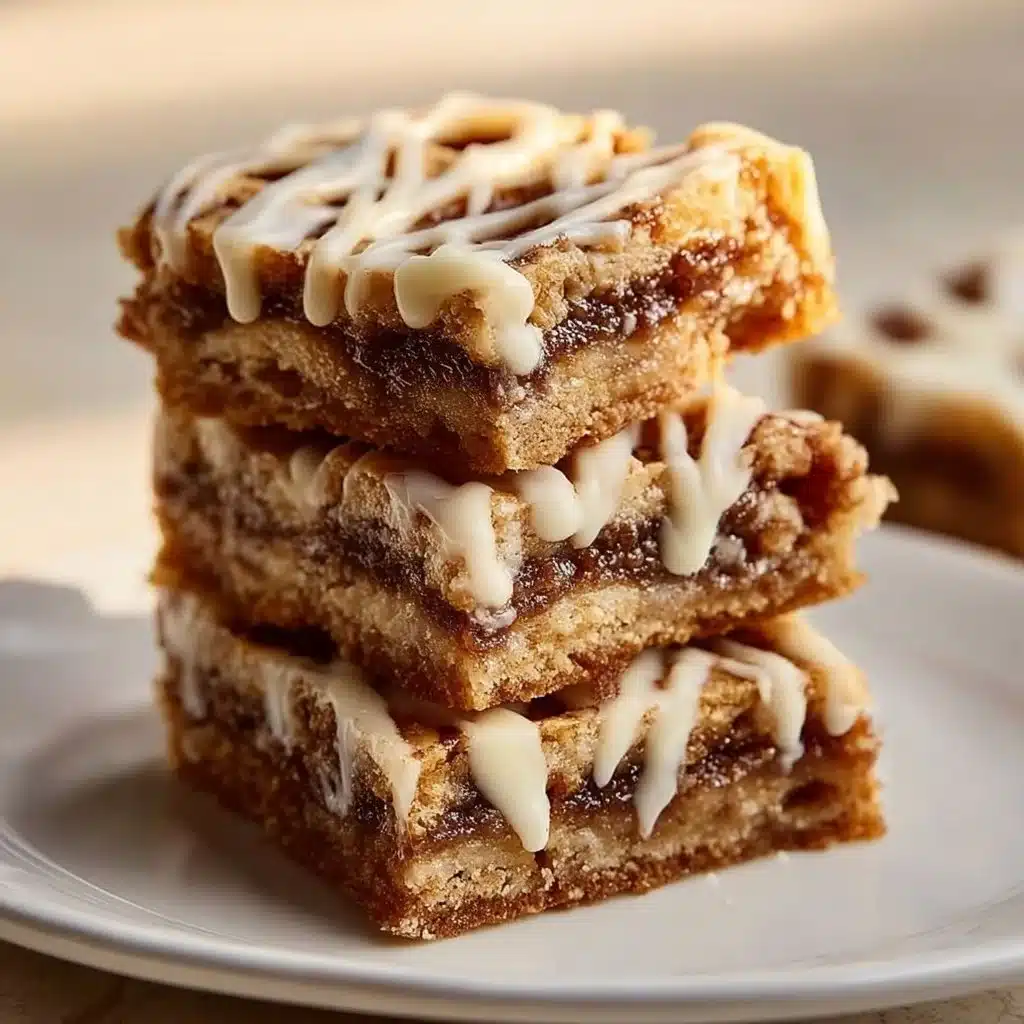 Homemade cinnamon roll bliss bars topped with creamy icing and cinnamon